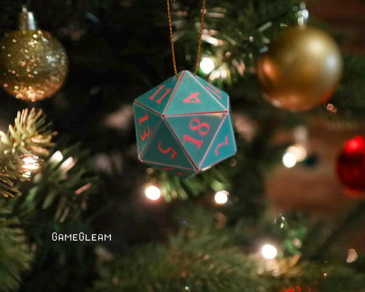 Green twenty-sided dice ornament with red numbers hanging on a decorated Christmas tree