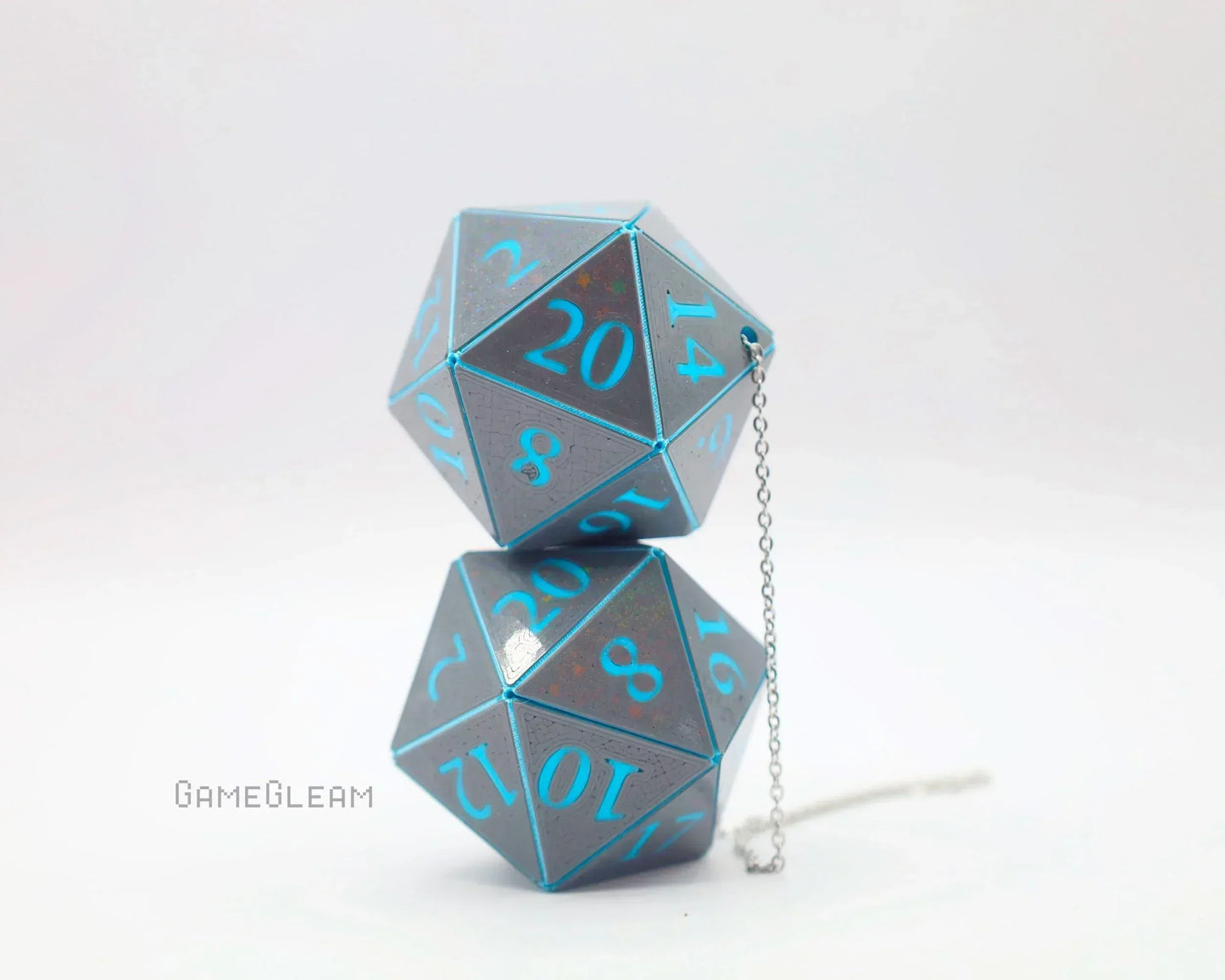 Handmade holographic D20 dice car charm with blue numbers and metallic finish on white background