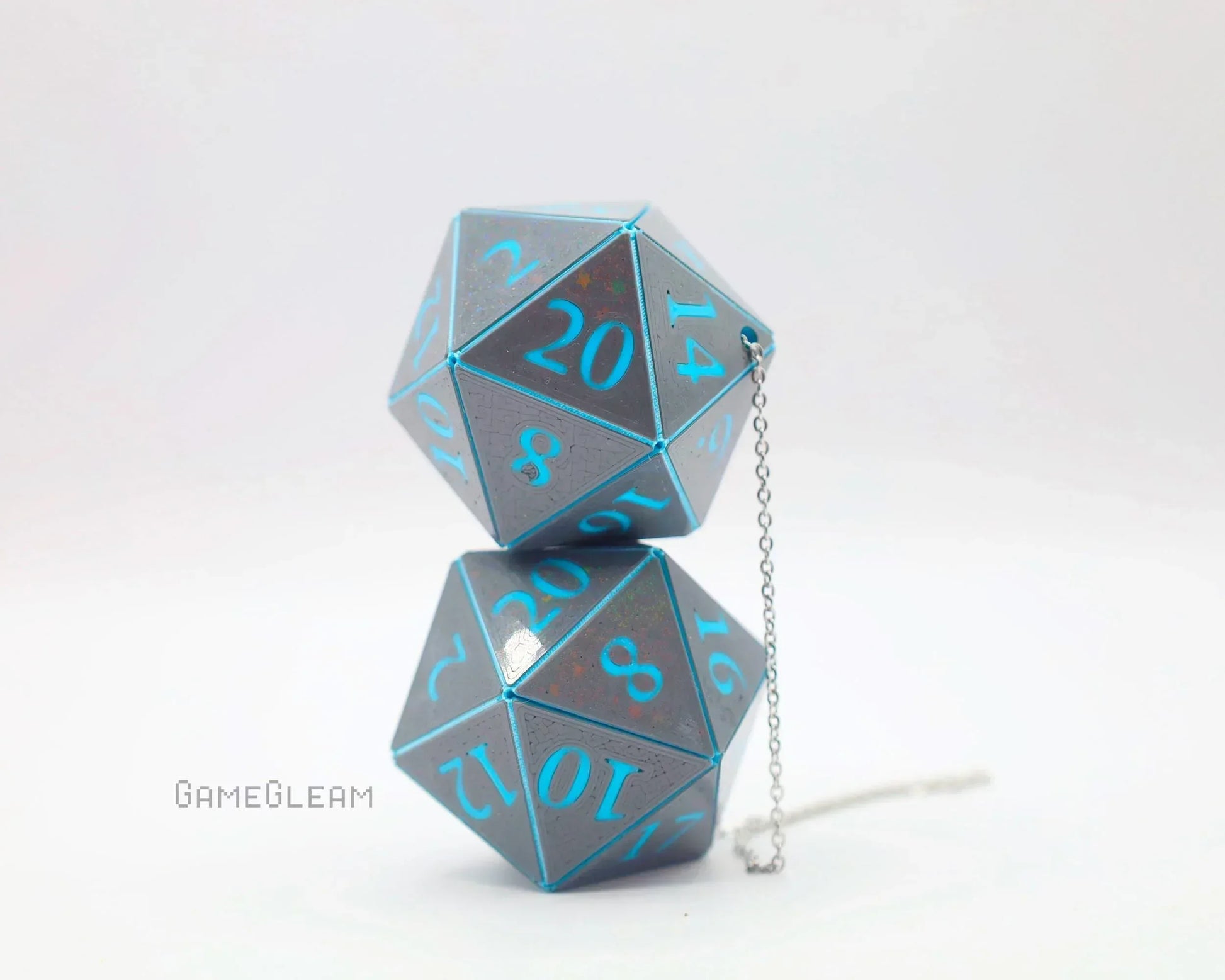 Handmade holographic D20 dice car charm with blue numbers and metallic finish on white background