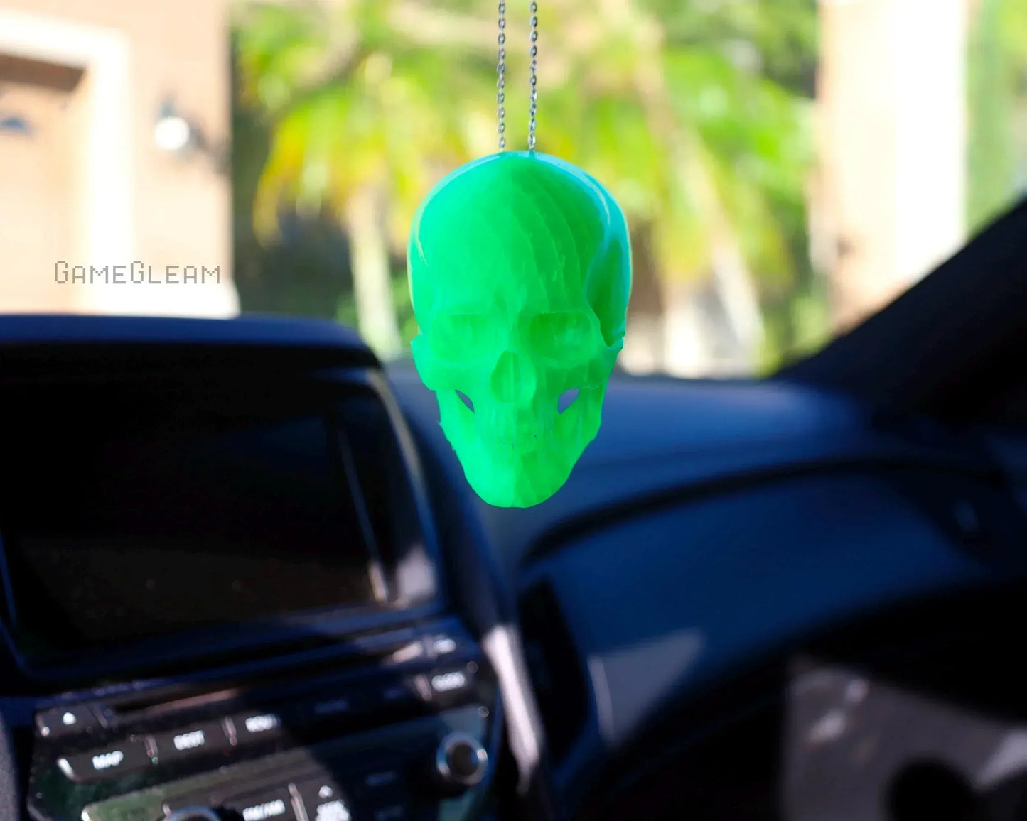 Neon green skull car charm hanging from rearview mirror, handmade geeky car accessory