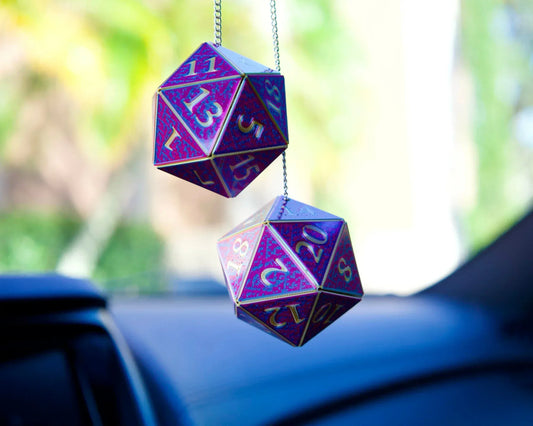 Holographic purple D20 dice car charms hanging from rearview mirror, blurred car interior