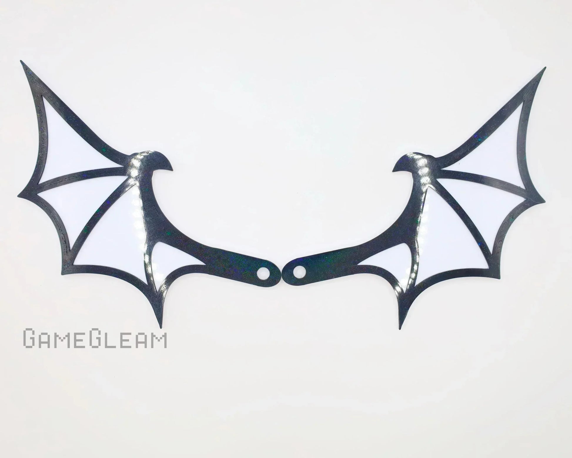 Pair of holographic black and white bat wing shaped car mirror charms on white background
