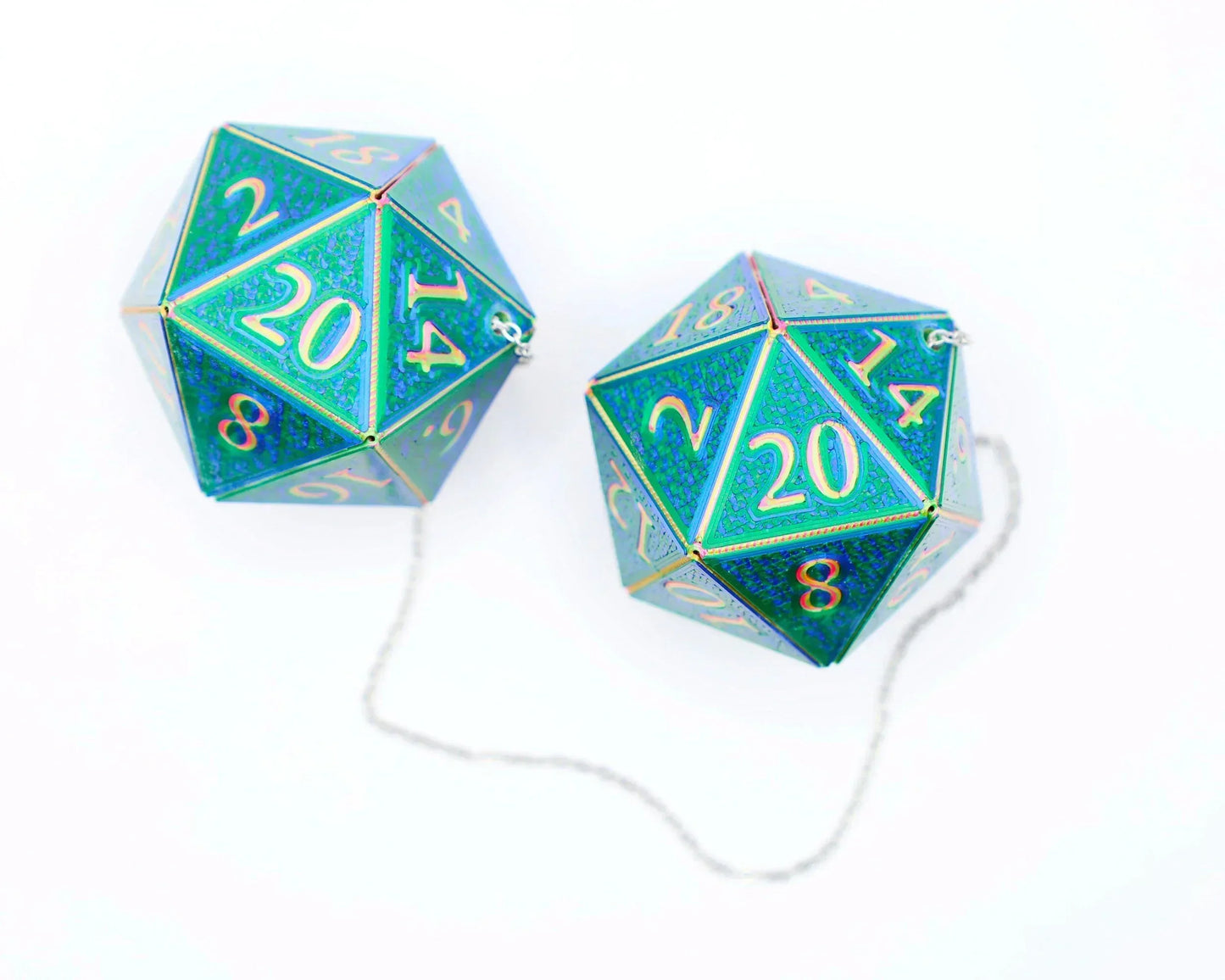 Pair of holographic blue green 20-sided dice car charms with silver chain on white background