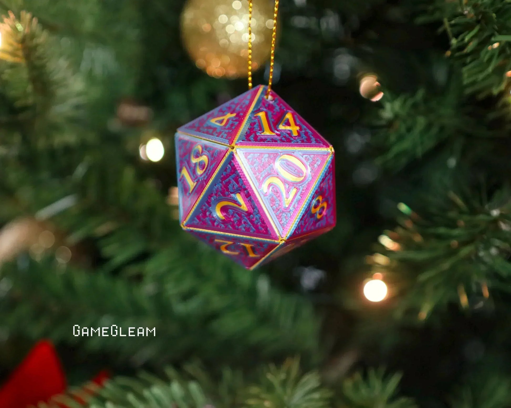 Holographic purple and gold twenty-sided dice ornament hanging on a Christmas tree branch