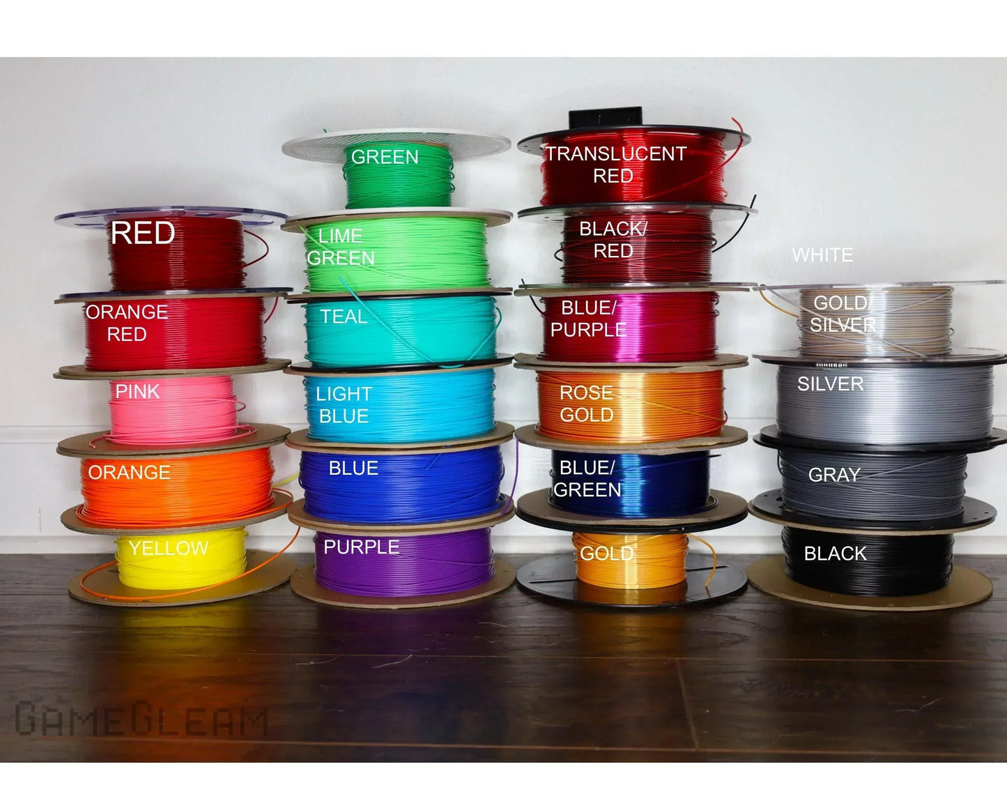 Multiple colorful spools of crafting wire labeled with names like red, green, teal, gold, and silver.