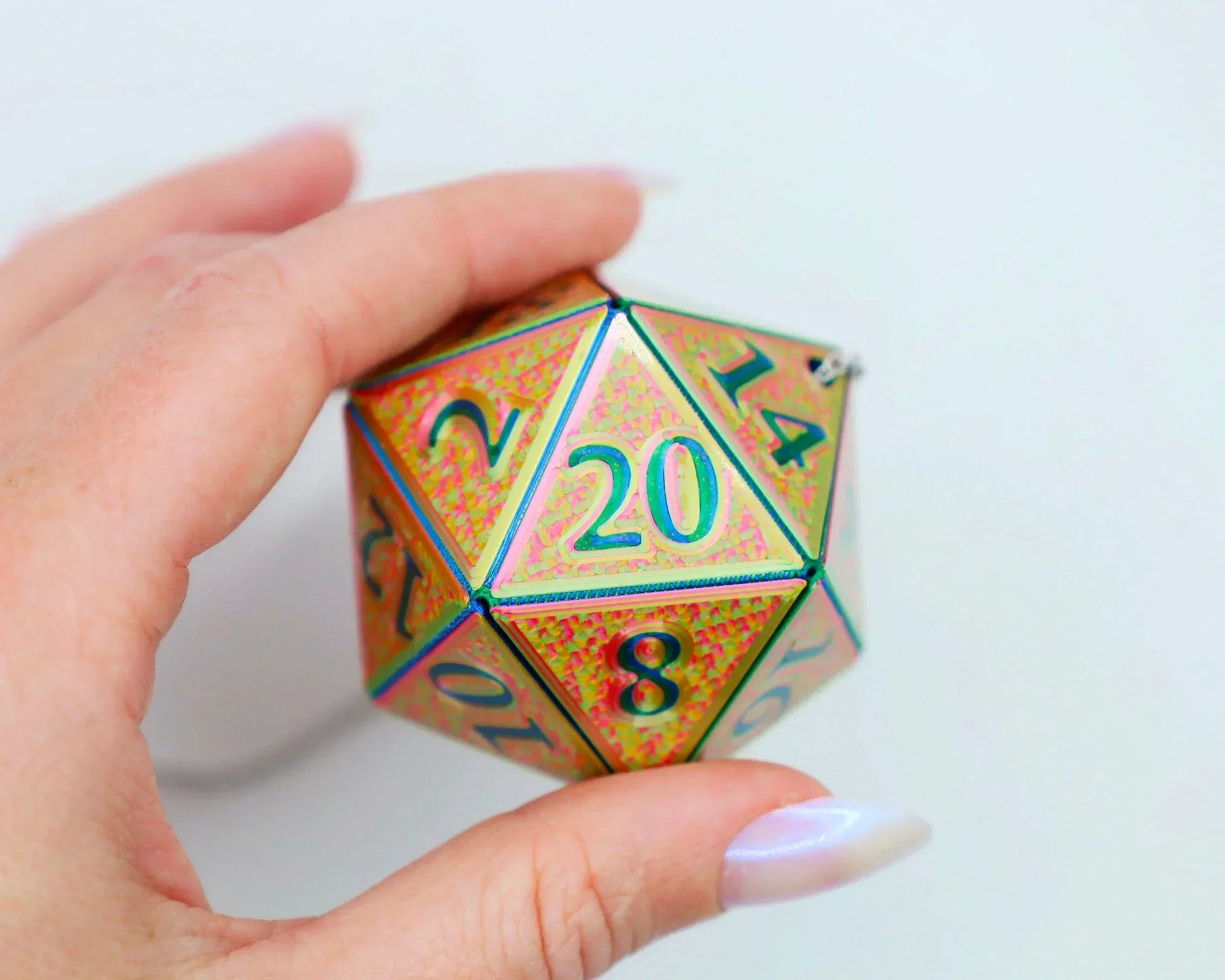 Hand holding a holographic twenty-sided dice car charm for tabletop RPG fans