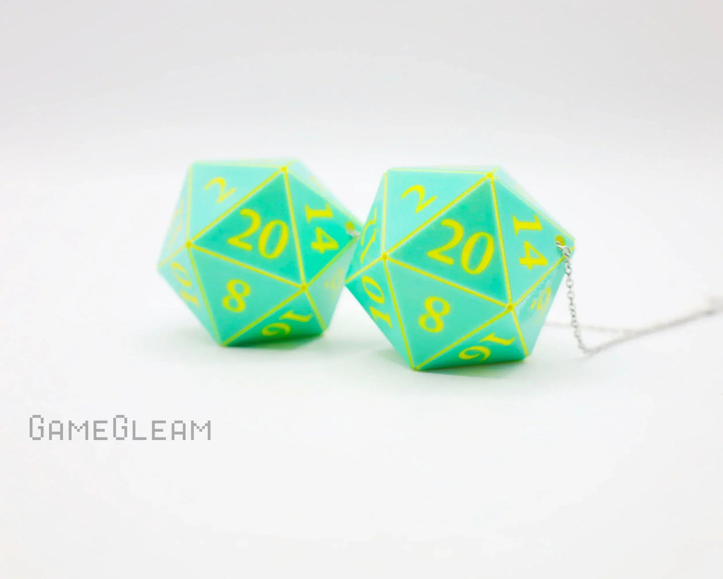 Pair of teal and yellow twenty-sided dice car charms with chain on white background