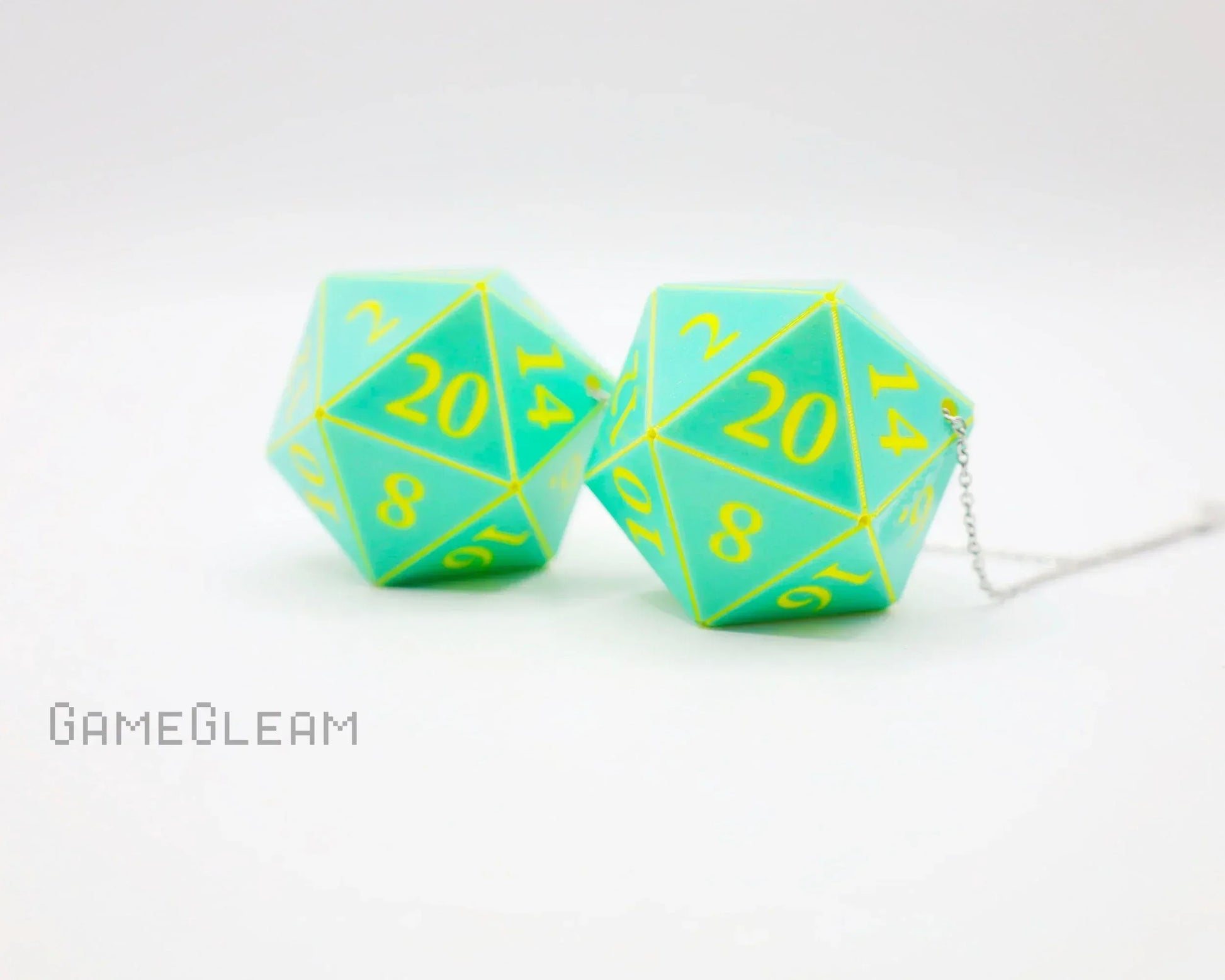 Pair of teal and yellow twenty-sided dice car charms with chain on white background