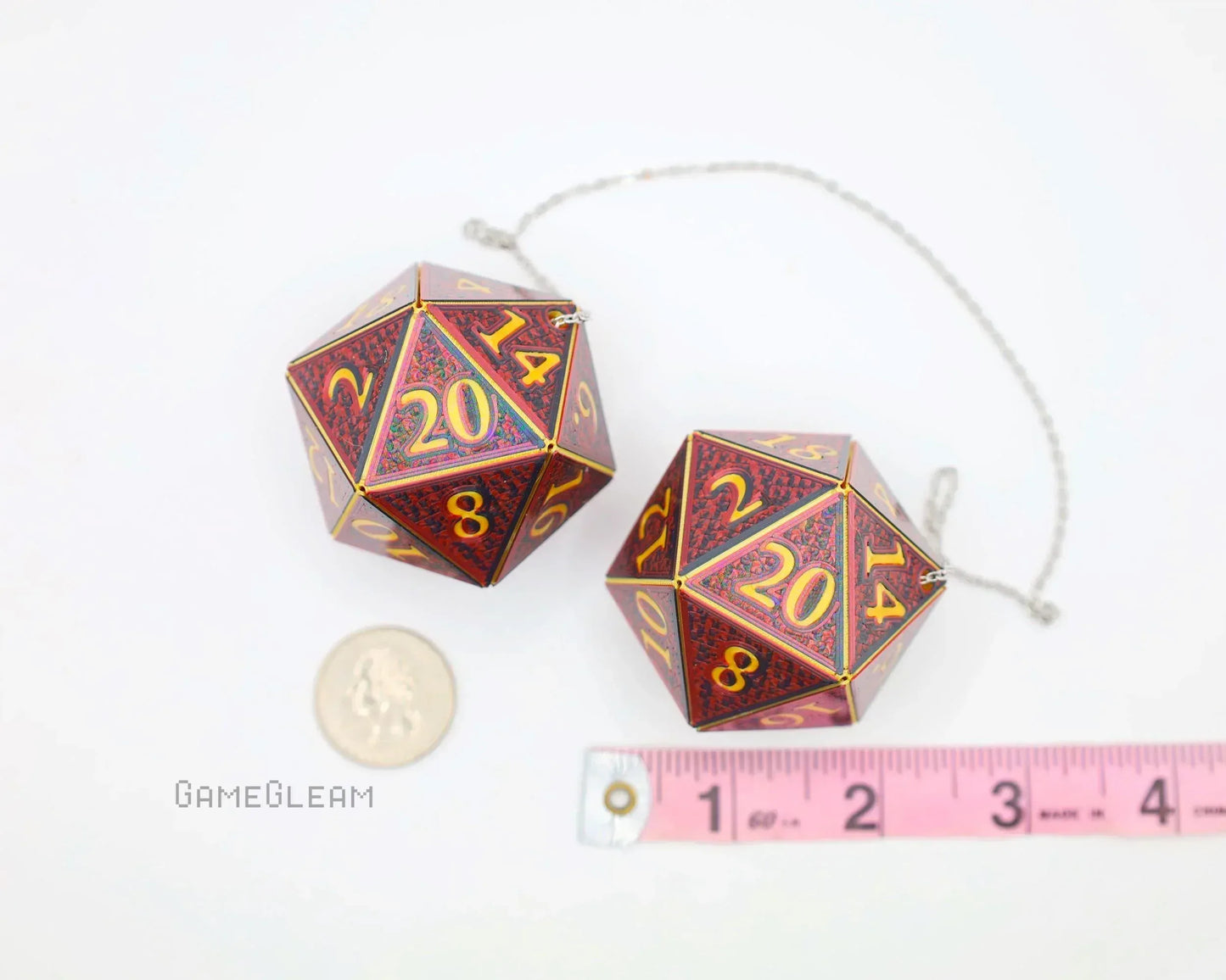 Pair of holographic red twenty-sided dice charms with gold numbers, shown with chain and size scale.