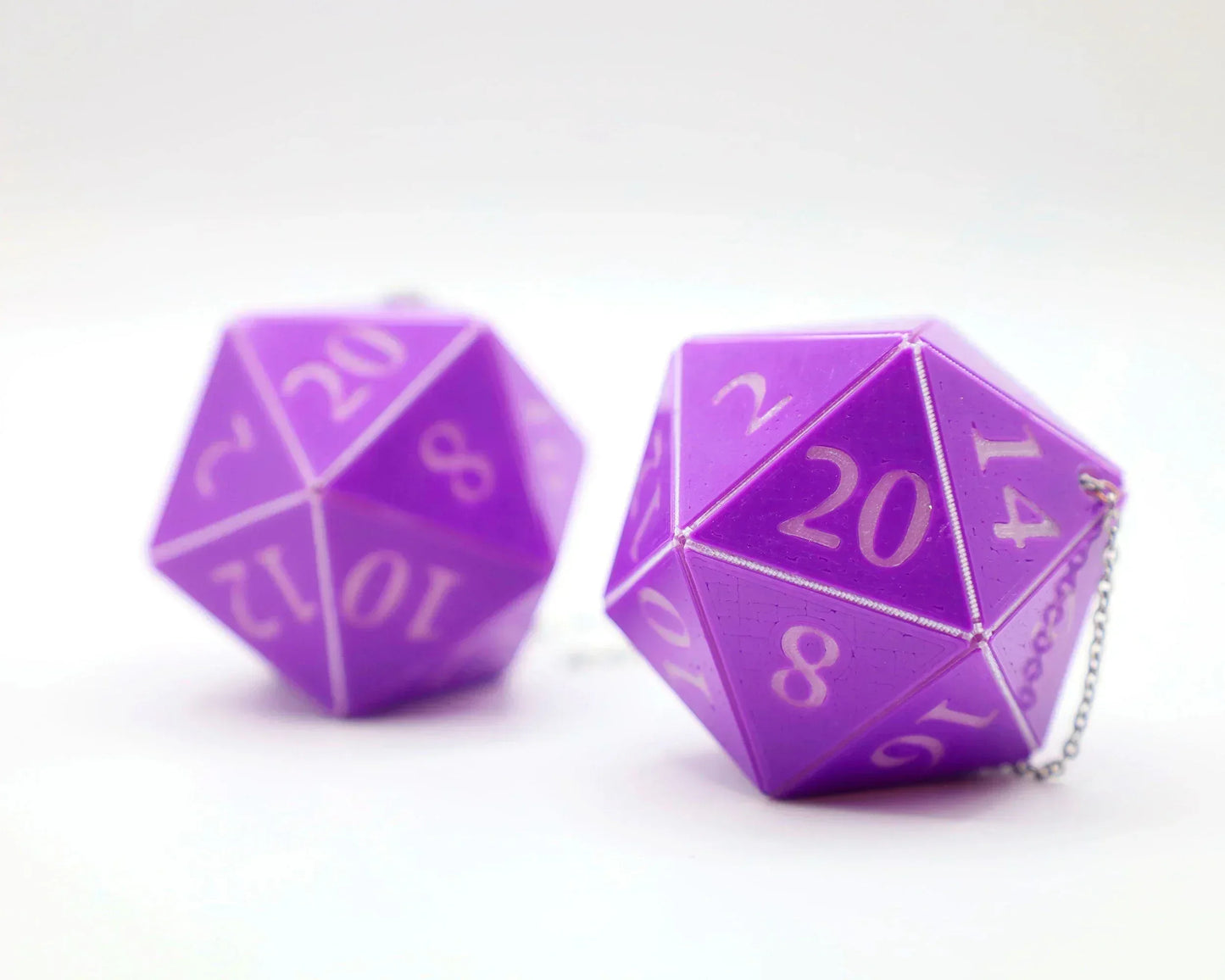 Purple twenty-sided dice car charms with white numbers, silver chain, on white background