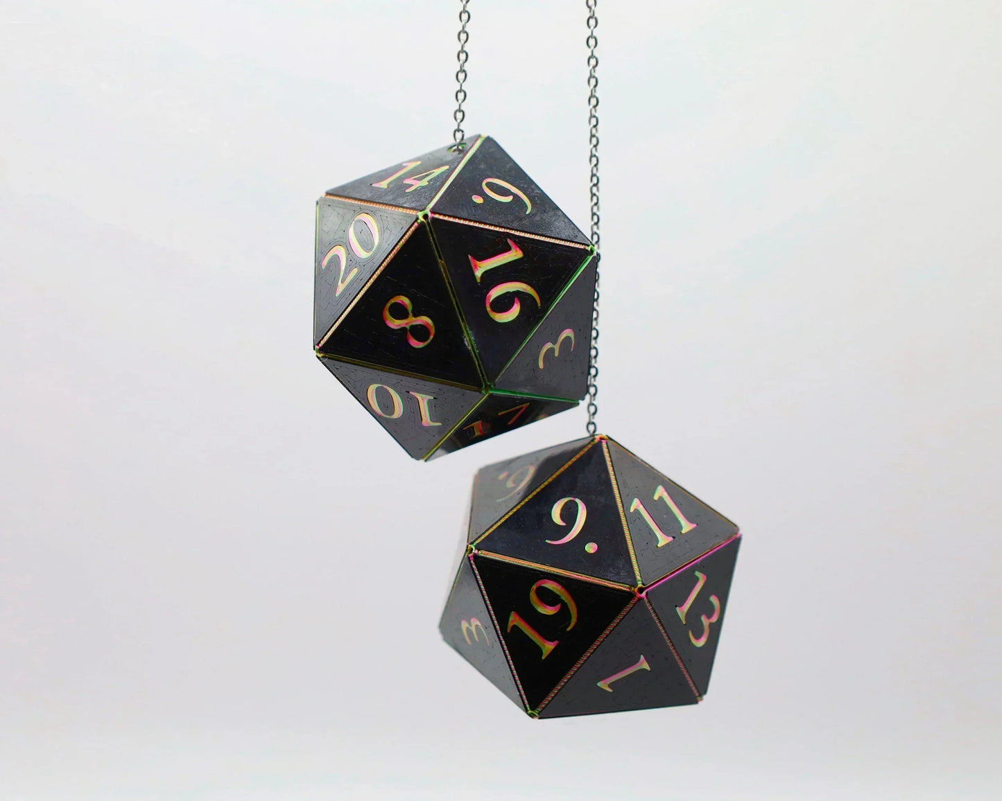 Handmade holographic twenty-sided dice charms hanging from chains, black with rainbow numbers