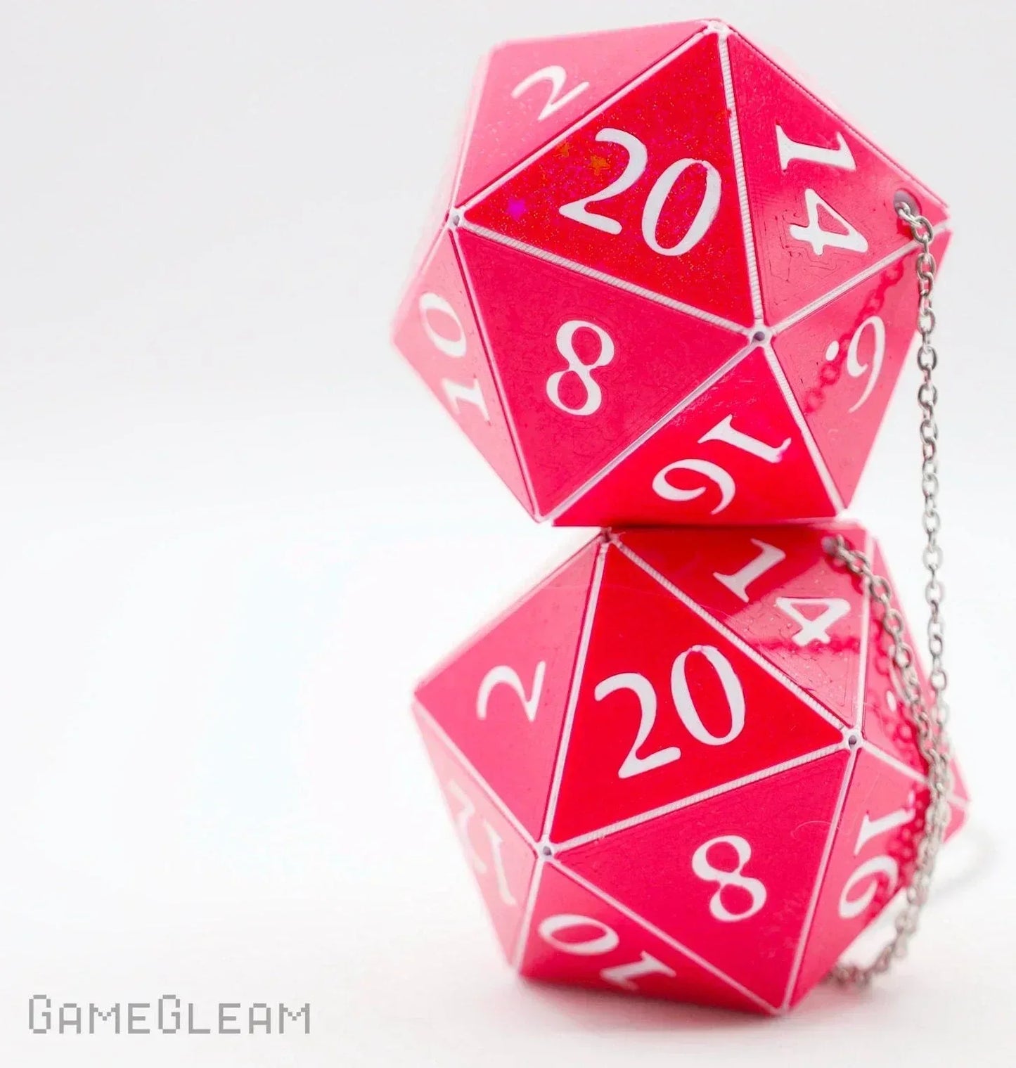 Pair of large pink twenty-sided dice with white numbers and a silver chain, ideal as gamer car charm.