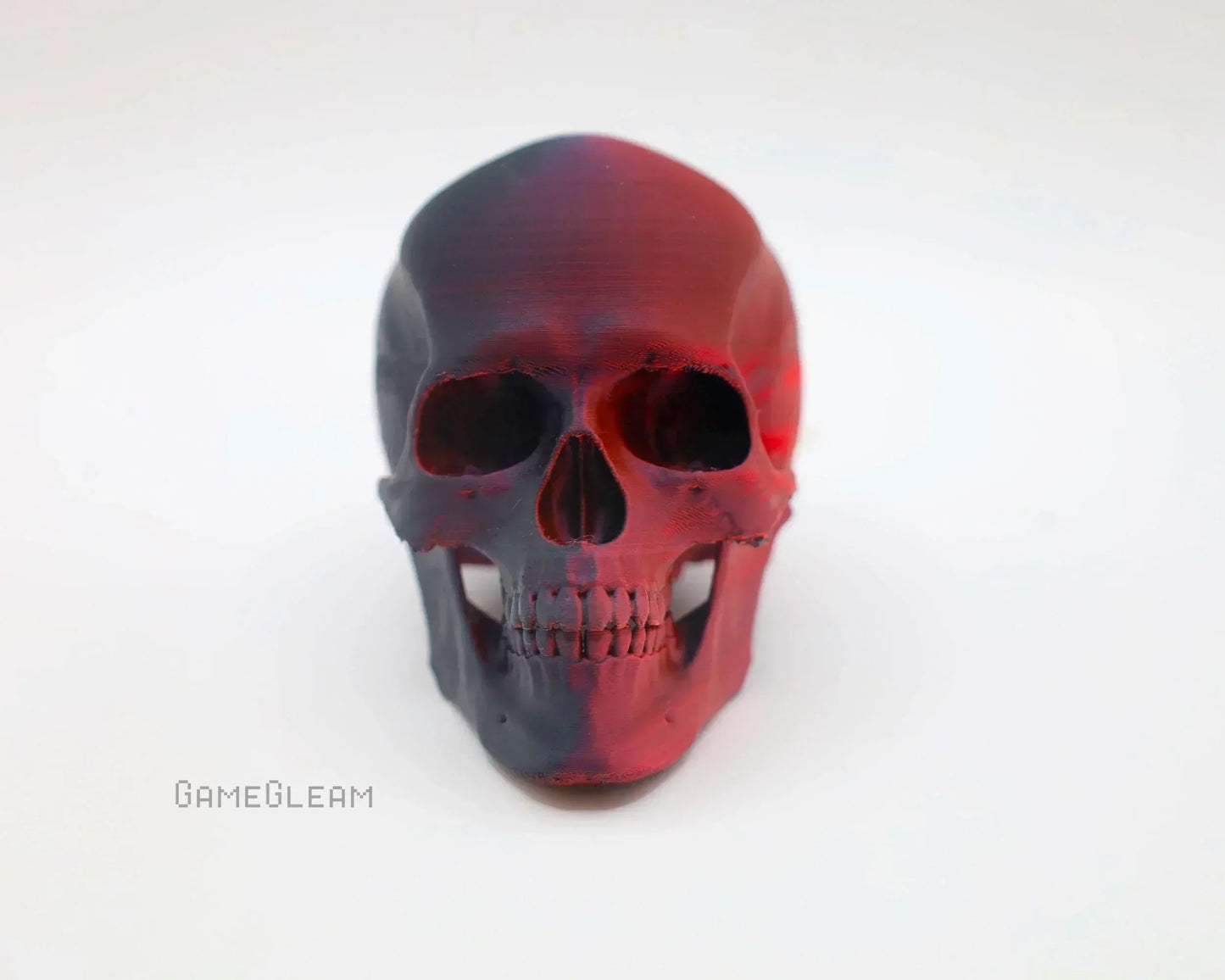 Red and black resin skull figurine on a white background, handmade gamer decor