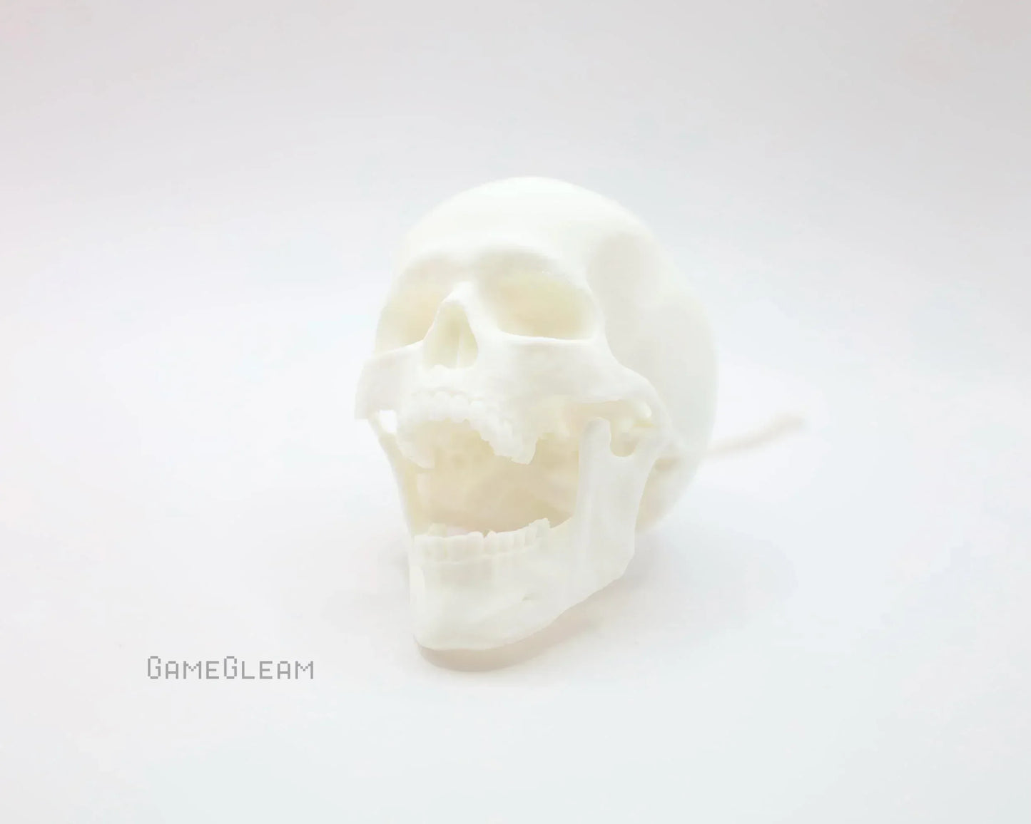 White 3D printed skull with hinged jaw on soft white background, gamer gift decor