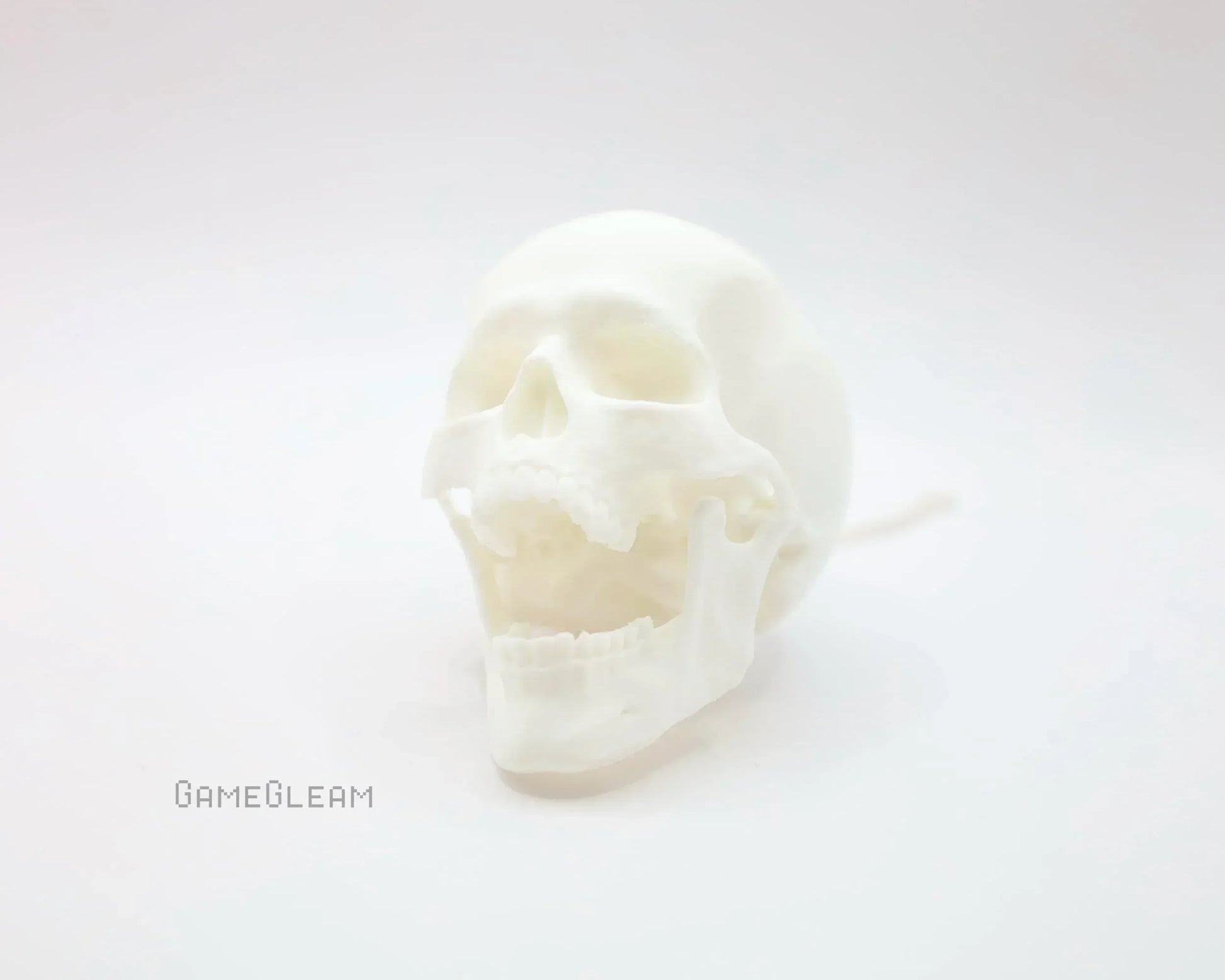 White 3D printed skull with hinged jaw on soft white background, gamer gift decor