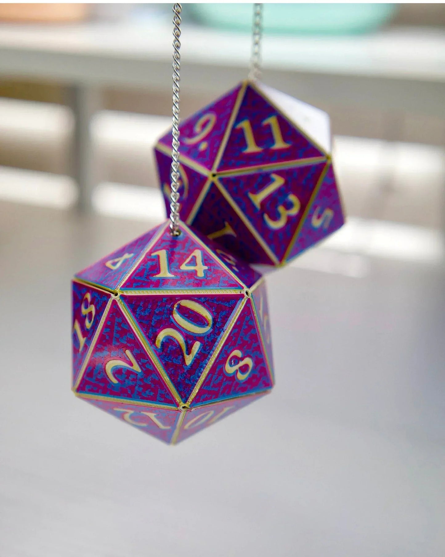 Holographic purple and blue twenty-sided dice car charm for tabletop RPG fans