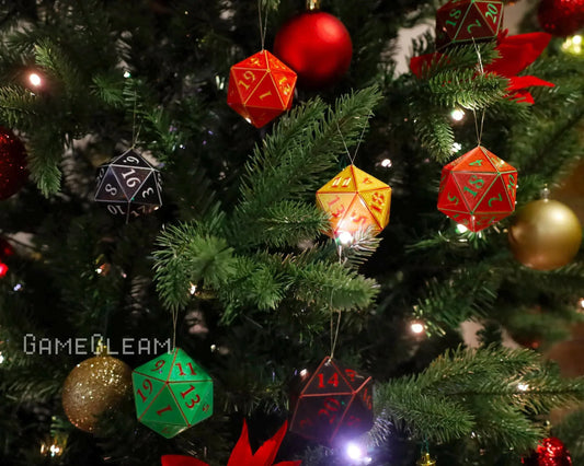 Colorful 20-sided dice ornaments hanging on a decorated Christmas tree with lights.