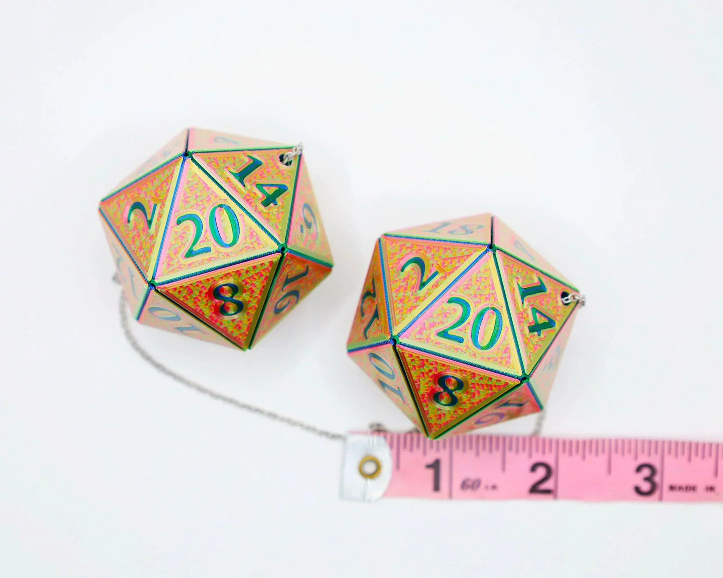 Holographic 20-sided dice car charms with measuring tape on white background