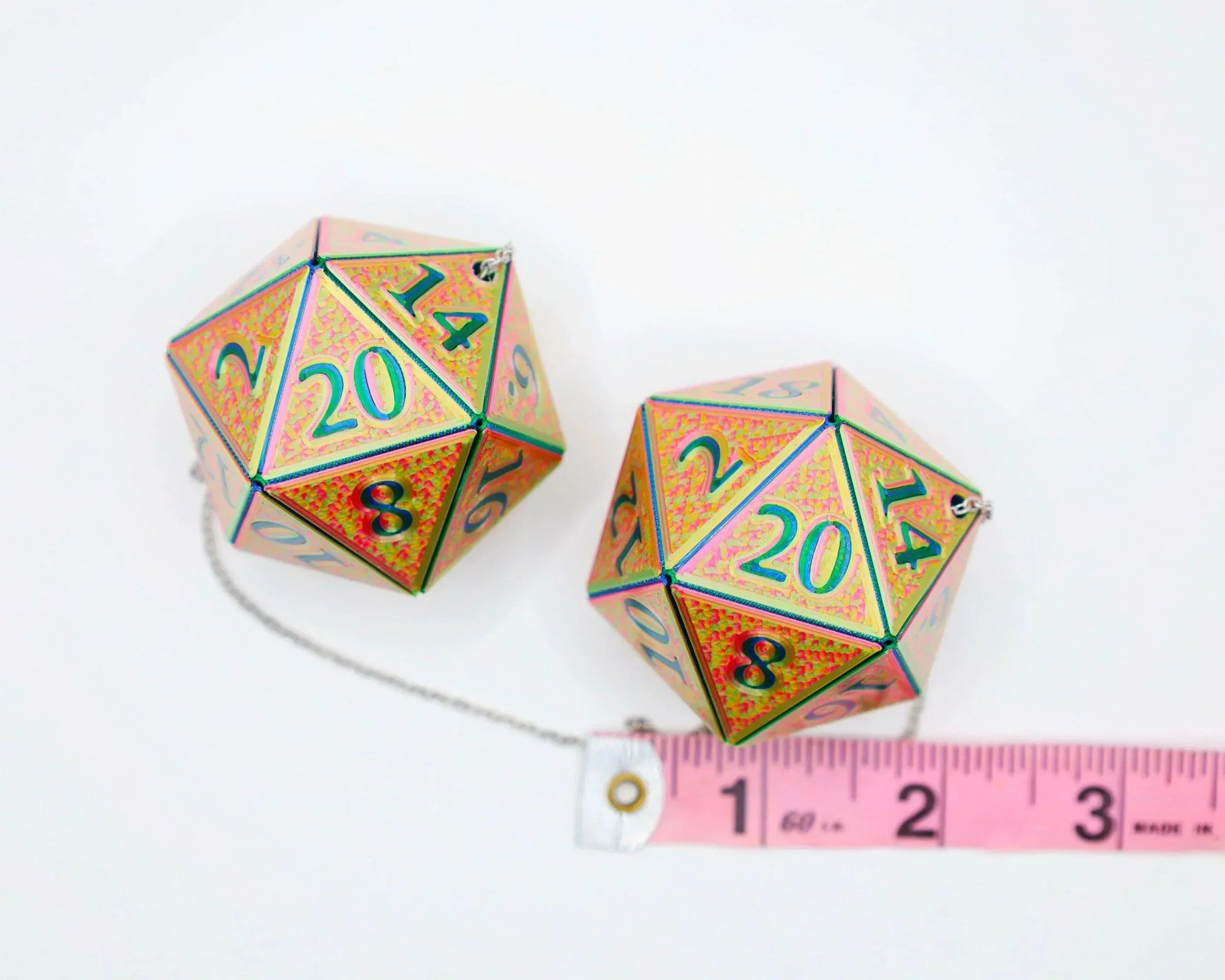Holographic 20-sided dice car charms with measuring tape on white background