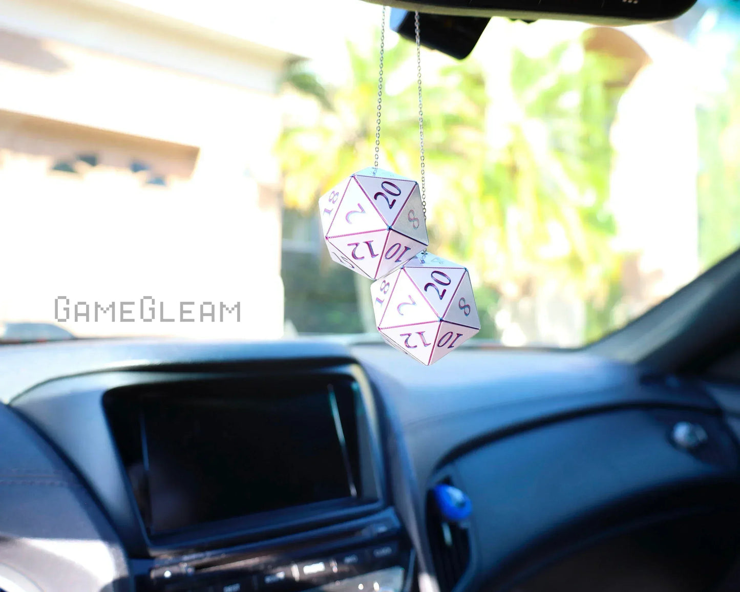 Pair of white holographic twenty-sided dice hanging from a car mirror as a unique gamer accessory