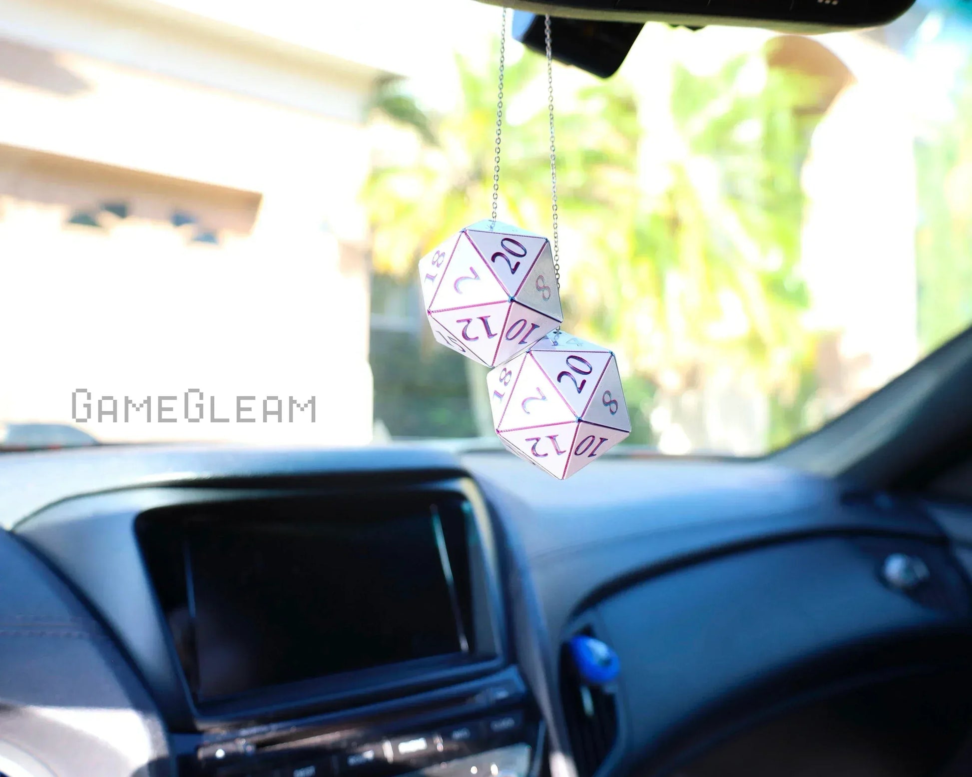 Pair of white holographic twenty-sided dice hanging from a car mirror as a unique gamer accessory