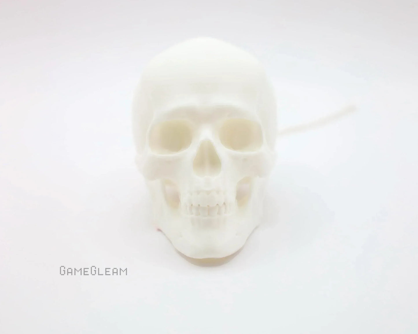 White skull-shaped soy candle on a clean white background, gothic home decor gift