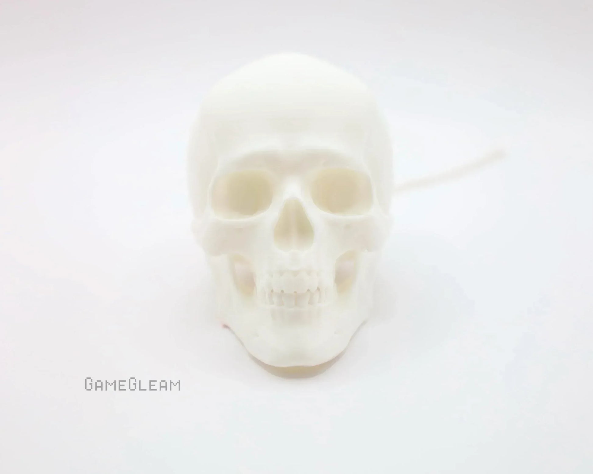 White skull-shaped soy candle on a clean white background, gothic home decor gift