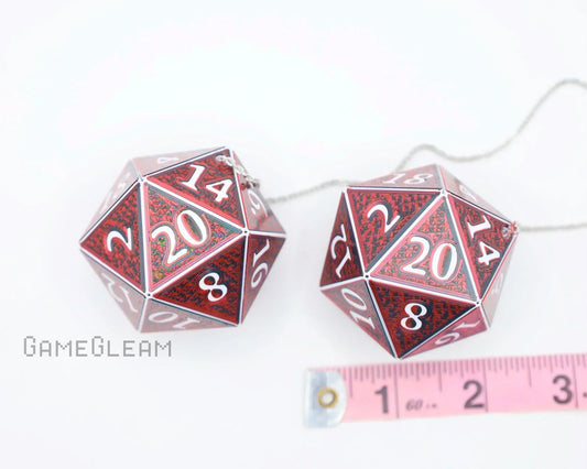 Red holographic 20-sided dice car charms with white numbers, shown with measuring tape.