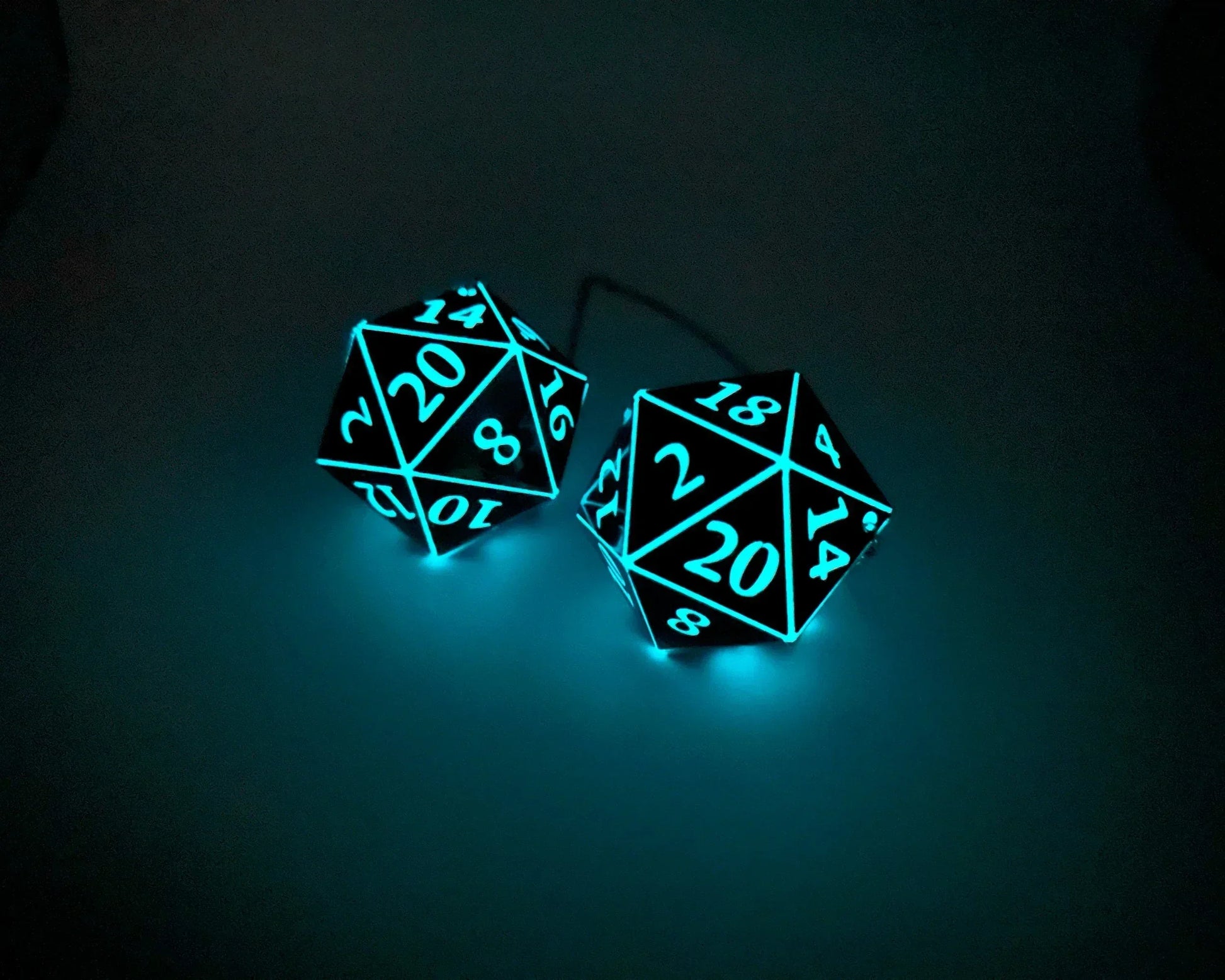 Glowing teal polyhedral dice car charm for tabletop gaming fans
